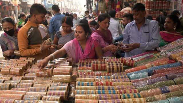 People, many not wearing face masks, shop for bangles in a market on the eve of Karva Chauth, in Amritsar on November 3. The rise in the number of daily infections indicates that the spread of the infection is unabated amid the festive season, but with recoveries also going up, the number of active cases remains under 5 lakh.